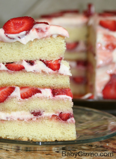 piece of vanilla cake with strawberries and frosting