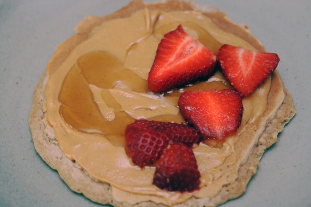 Pancake with peanut butter, syrup and strawberries