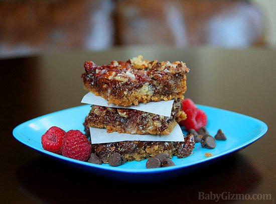 raspberry magic bars stacked on a plate