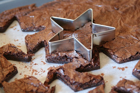 star cookie cutter cutting brownies in baking sheet