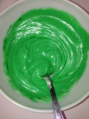 green frosting in white bowl