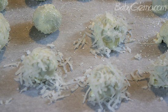 coconut covered dessert balls on wax paper