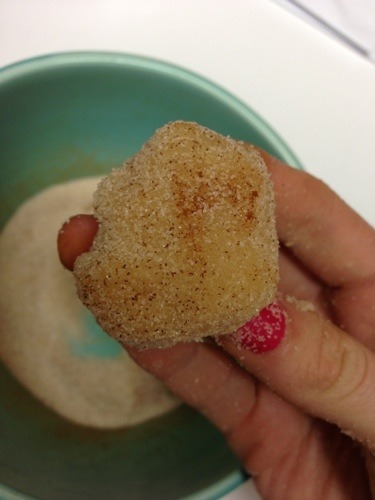 cookie dough ball covered in sugar in hand