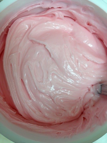 pink frosting in blue bowl