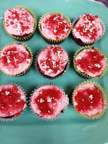 pink frosted cupcakes on blue plate