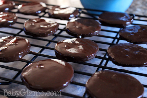mint cookies with melted chocolate on cooking rack