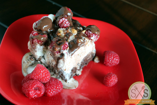 raspberries ice cream brownie on red plate
