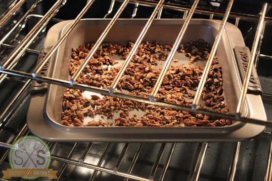 toasted pecans in a pan in an oven