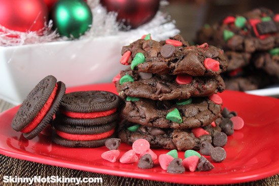 stack of chocolate cookies on red plate christmas ornaments in background