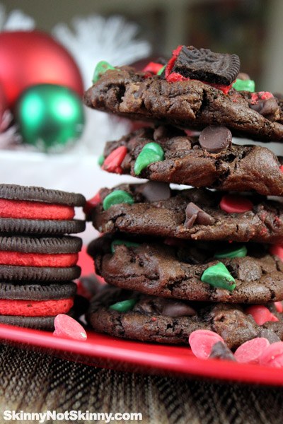 big stack of chocolate holiday cookies stacked next to oreos